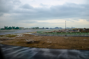 Looking from the airplane window of the landing scene. The scene of the airport apron. Travel and transportation concept.
