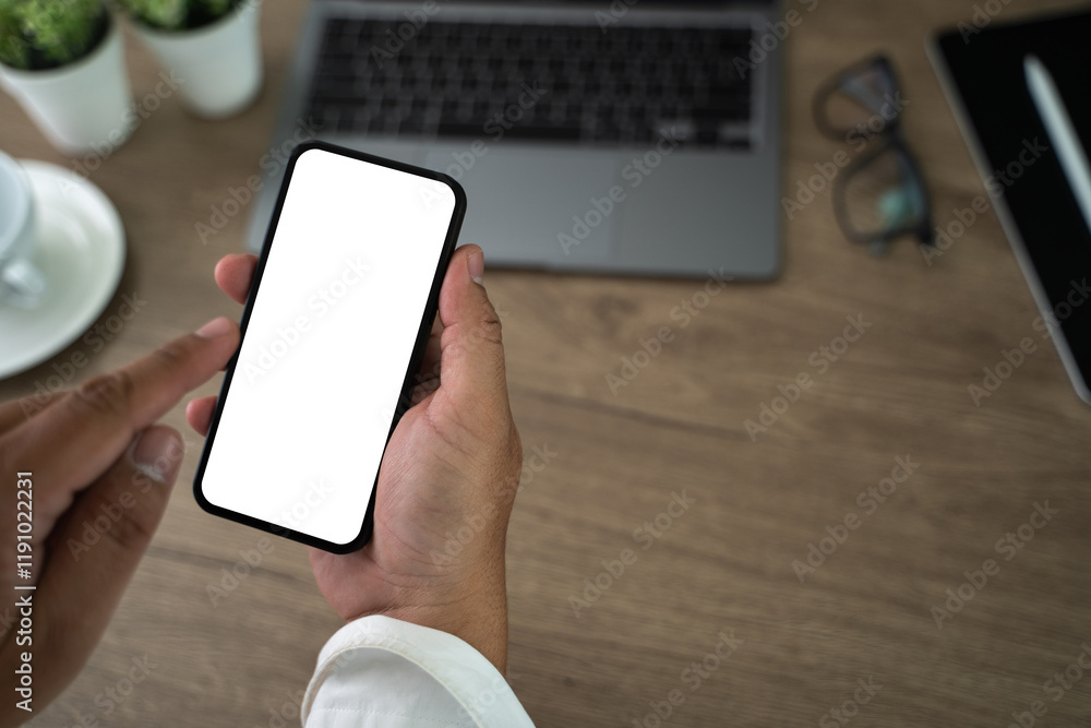 Poster top view mockup image hand using a smartphone man holding cell phone with blank screen