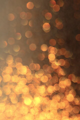 A bokeh effect photograph, out of focus lights creating a golden circles texture background, flame-like effect