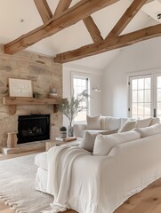 Cozy farmhouse-style living room with a white slipcovered sofa, exposed wooden beams, and a stone fireplace as the centerpiece.