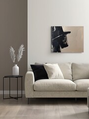Minimalist living room interior design with a low-profile beige sofa, black metal side tables, and abstract monochrome artwork on the wall.