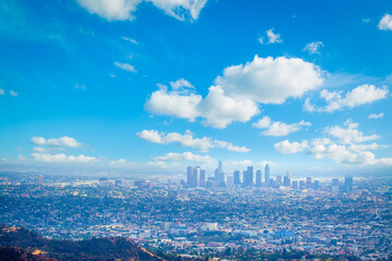 Los Angeles skyline under a blue sky with clouds