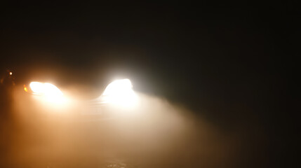 Headlights of a car in foggy weather