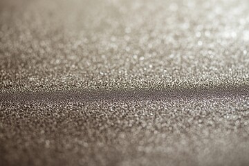 A close-up view of a shimmering, textured surface with a subtle gradient.