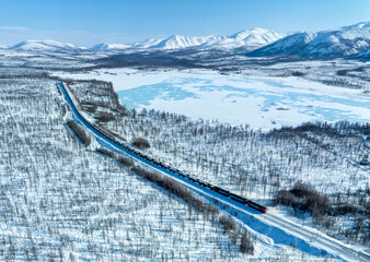 Cargo train high in the snowy mountains. Freight transport industry