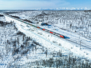 Railway in the snowy mountains. Cargo transportation industry