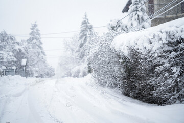 Obraz premium Snow covered winter road during snowstorm
