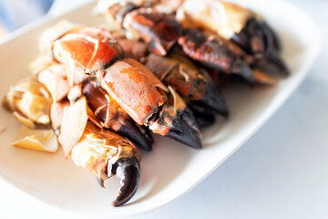 Steamed stone crab claws served with a spicy seafood dipping sauce are popular dishes in local street food in Thailand.