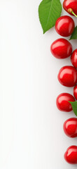 Ripe cherries and cherry slices with green leaves arranged on white background. Cherry wallpaper, banner