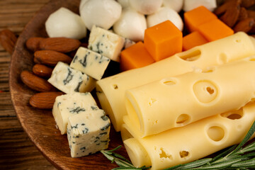Cheese plate of color cheeses variety, yellow, white and blue cheese board, assorted dairy products
