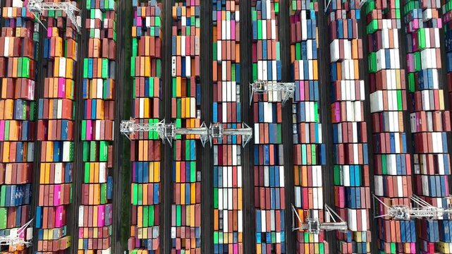 4K Drone shot of modern industrial container port of Rotterdam with containers from top view. It is an import and export cargo port where is a part of shipping dock