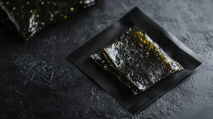 Seaweed chips in a modern packaging isolated on a sleek black surface