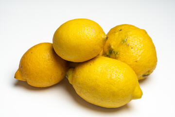 Fresh Yellow Lemons Piled Together on a Clean White Background