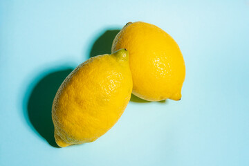 Fresh Ripe Yellow Lemons on Vibrant Blue Background