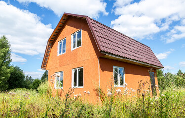 New small unfinished wooden house at the countryside in summer