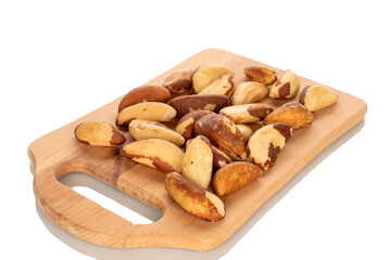 Brazil nuts without shells on a wooden kitchen board, close-up, isolated on a white background.