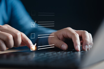 checklist, checkbox, document, plan, tick, choose, check, choice, checkmark, choosing. A person is typing on a laptop with a checkmark on the screen. a task or is in the process of completing.