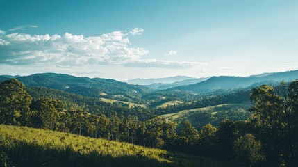 Naklejka premium Serene Landscape View of Rolling Hills Under Clear Blue Skies