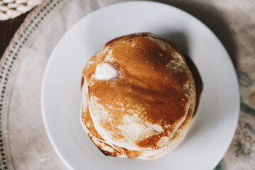 Hot homemade stack of pancakes with butter on plate. Breakfast, brunch time. High quality photo