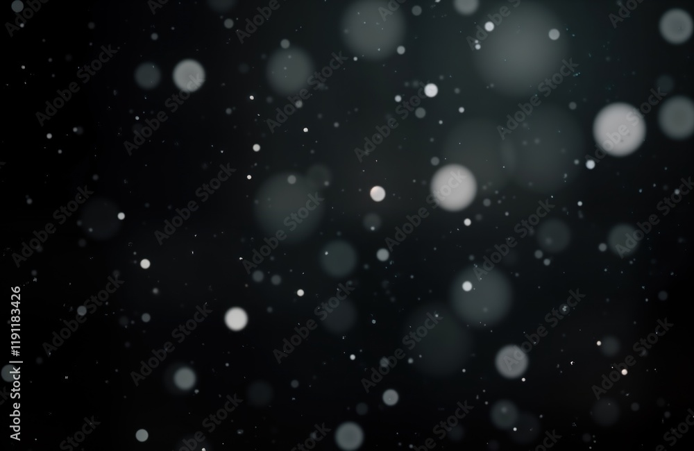 Poster bokeh effect shows falling snow in darkness. white snowflakes appear as blurred circles on dark back