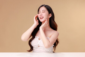 Fototapeta premium Beauty portraits of young Asian woman with clean fresh skin on beige background. Cute female model, beauty blogger make up artist in studio. Skincare, plastic surgery, spa concept.