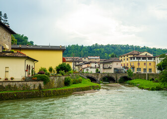 Obraz premium Cityscape with river and village of Sabbio Chiese, Brescia, Italy. Beautiful mountain village in Sabbia Valley in northern Italy. A medieval town in Lombardy.