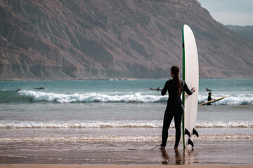 Female surfer with surf board beach sea scene