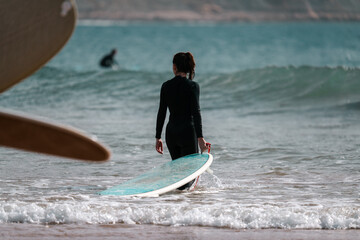 Female surfer with surf board beach sea scene