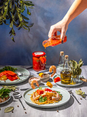 Chef pouring spicy sauce on gourmet shrimp scampi with flying ingredients