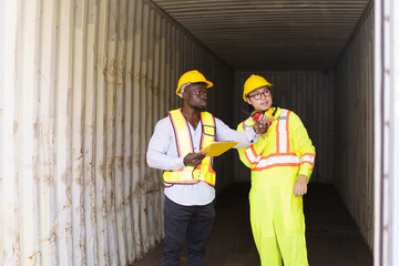 Engineers inspect a containers in container yard.