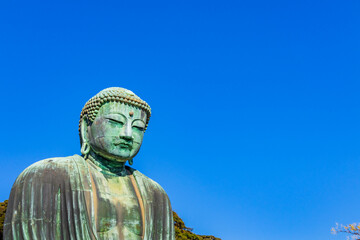 Ancient bronze statue of the Great Buddha Daibutsu at Kotoku-in temple in Kamakura, Japan. It is an important landmark and a popular destination for tourists.
