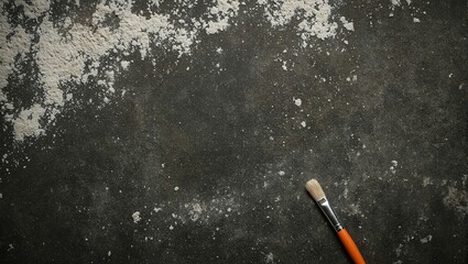Abstract concrete background with white dust and orange paintbrush