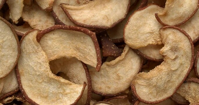 Dried sliced Asian pears background texture. Table spin.
