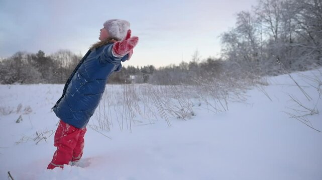 Child falling into soft snowdrift. Slow motion