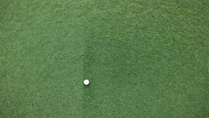 Vibrant green turf with a solitary golf ball for a striking practice setup