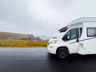 Camper van traveling on the e69 road to nordkapp, norway, on a rainy and foggy day