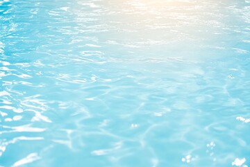 Obraz premium Sparkling blue pool water with ripples and sunlight reflections. Refreshing swimming pool surface. Summer relaxation and cooling off concept. Aquatic background for travel ads