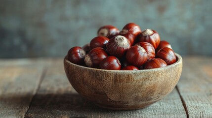 Obraz premium Bowl of Freshly Harvested Chestnuts on Rustic Wooden Table