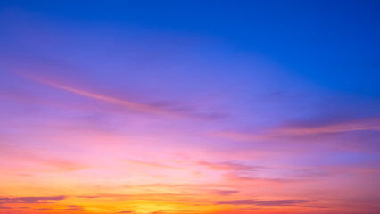 Sky summer sunset background with nature light and clouds on colorful yellow, orange and blue fantasy twilight sky, Beautiful horizon romantic dusk sky in the evening