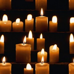 Three glowing candles burn brightly, casting a warm yellow glow against the darkness