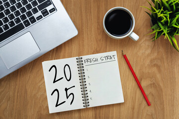 2025 Happy New Year Resolution Goal List and Plans Setting - Business office desk with notebook written about plan listing of new year goals and resolutions setting. Change and elation concept.
