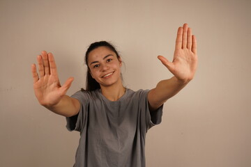 An open palm extended forward with both hands expresses a direct command to “stop.” This simple...