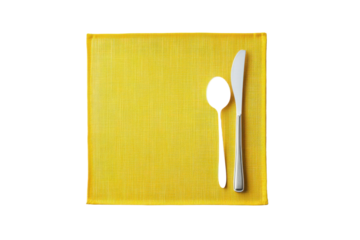 Elegant yellow placemat with a spoon and knife set ready for a dining experience at a cozy table setting