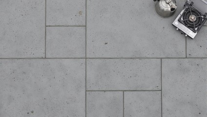 Outdoor cooking scene on slate gray tile camping stove  kettle in top right corner