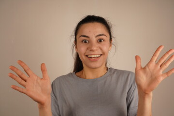 This gesture conveys an immediate reaction to something unexpected. The open palms and raised posture enhance the feeling of surprise. The arms are spread wide, expressing the emotion of surprise.