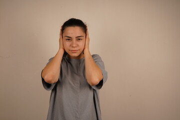 This gesture conveys a desire to avoid unpleasant information. It's a natural reaction to...
