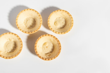 Large empty tartlets for snacks on white background. Top view