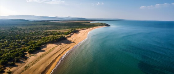 Obraz premium Scenic Aerial View of Tranquil Beach Meeting Serene Ocean and Sky