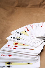 A deck of poker cards spread out on a table.