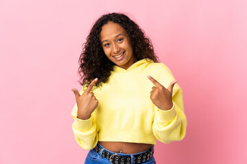 Teenager cuban girl isolated on pink background giving a thumbs up gesture